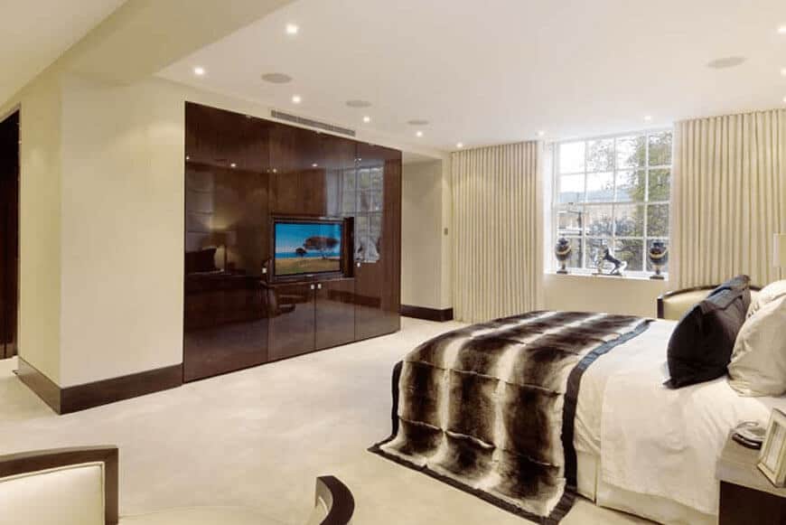 Luxury cabinet surrounding a television in a bedroom