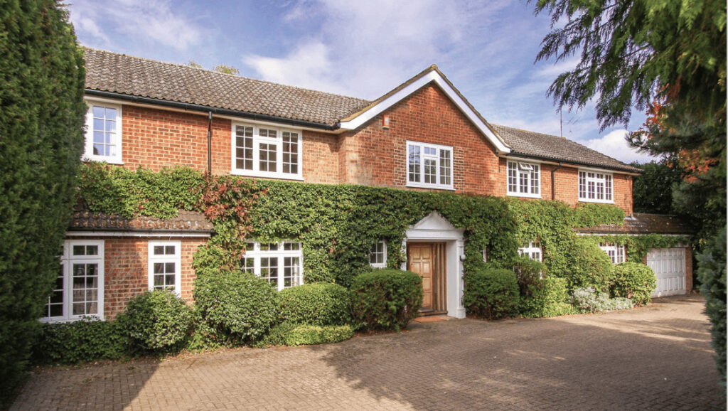 Ivy-clad brick house with a gravel driveway